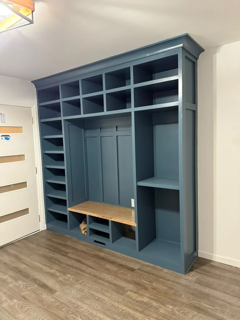 Deep blue built-in bookcase with wood bench seat