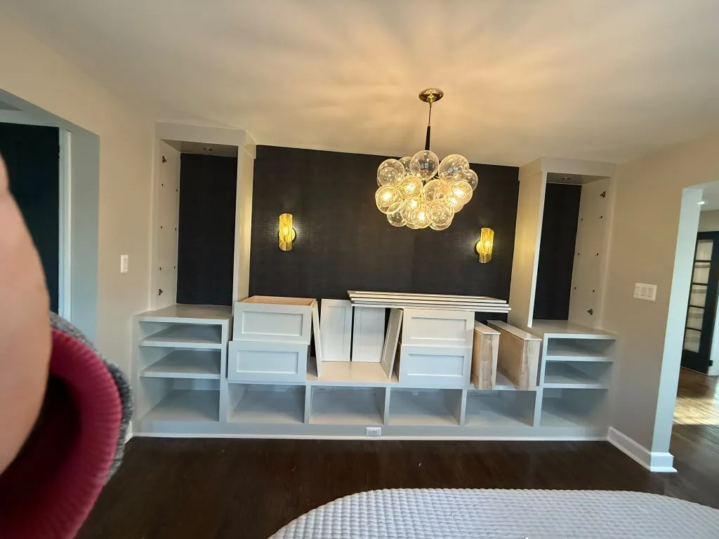 Built-in cabinetry and shelving along a dark feature wall