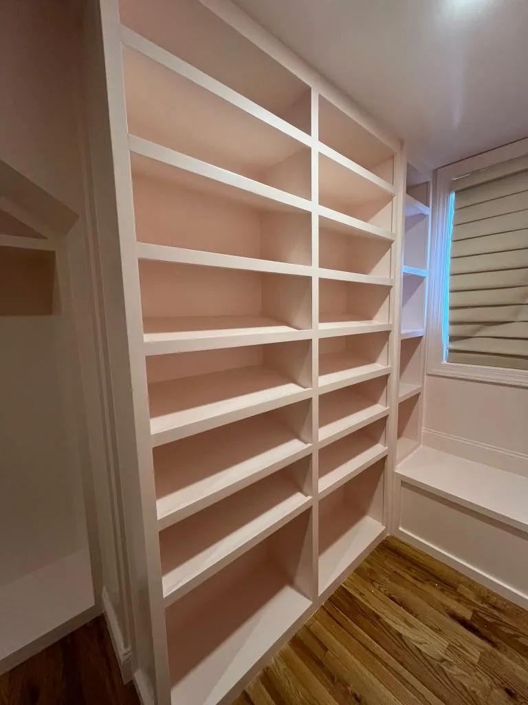 Floor to ceiling built-in shelving in a hallway