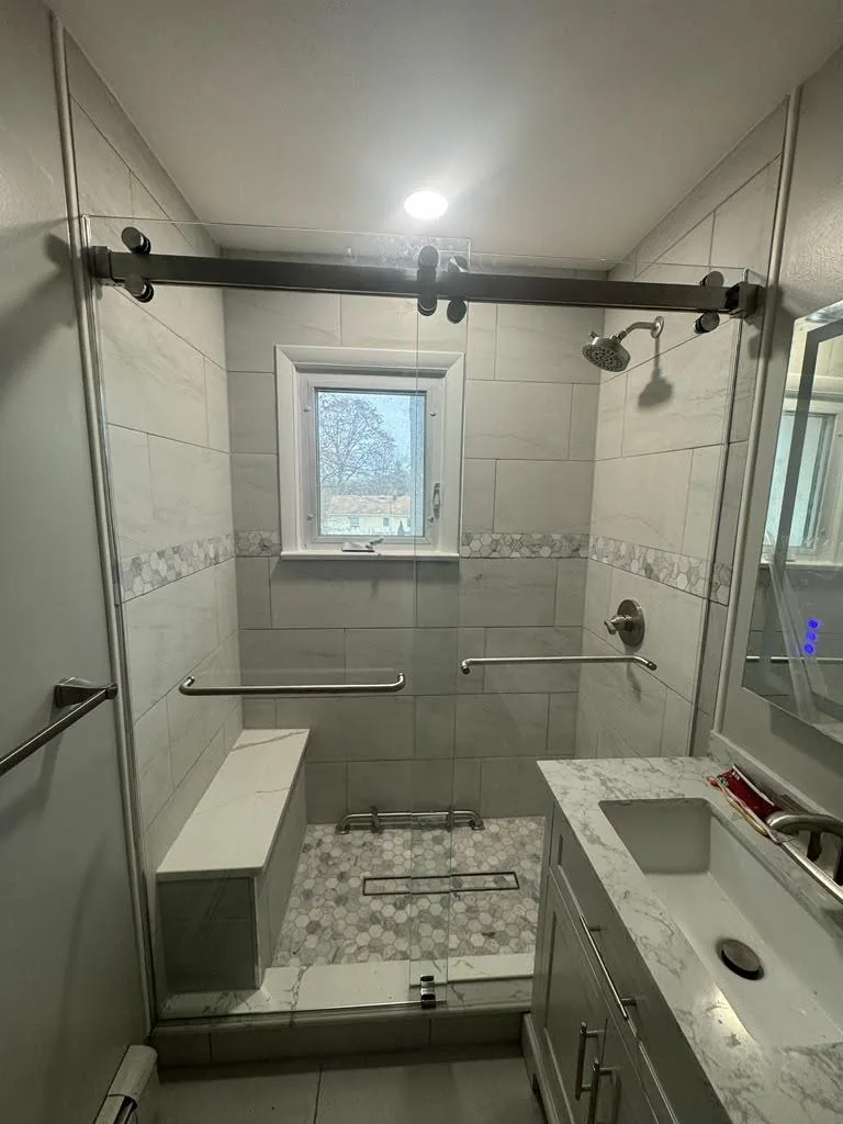 Barn style sliding glass shower door with black hardware