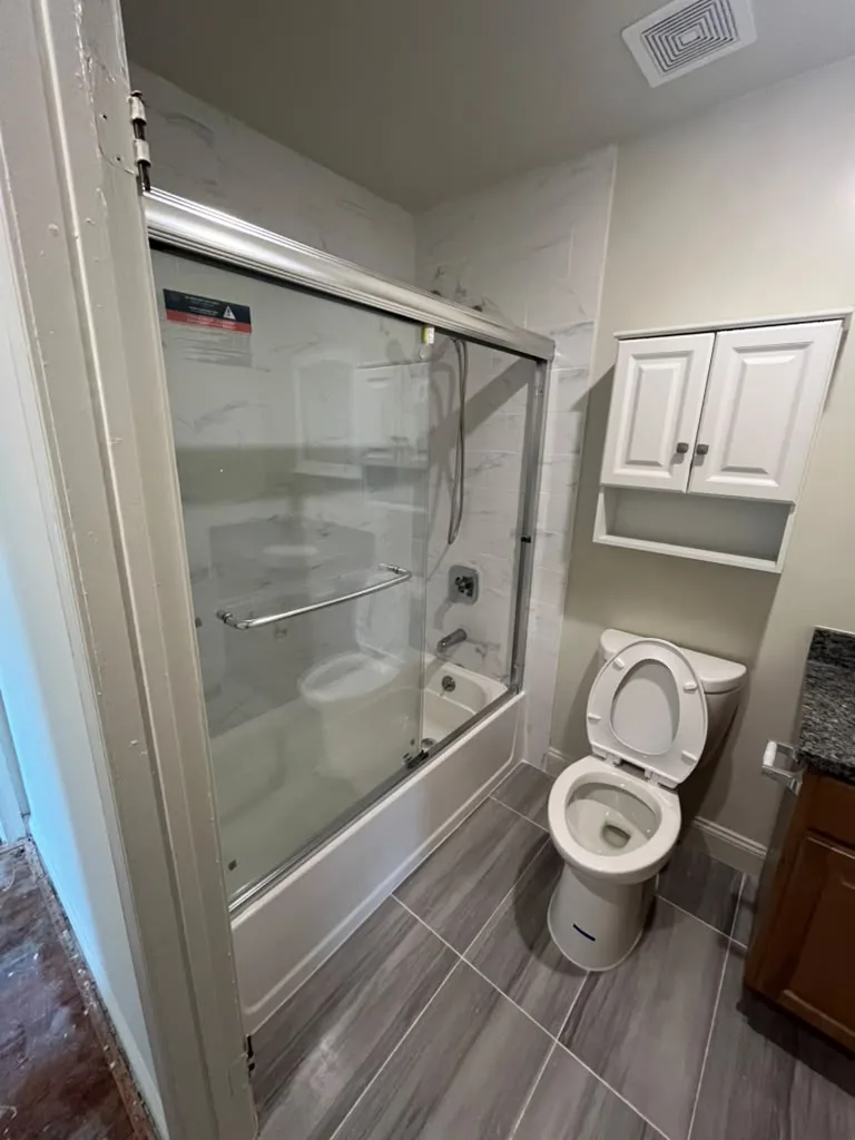 Glass tub enclosure with vanity
