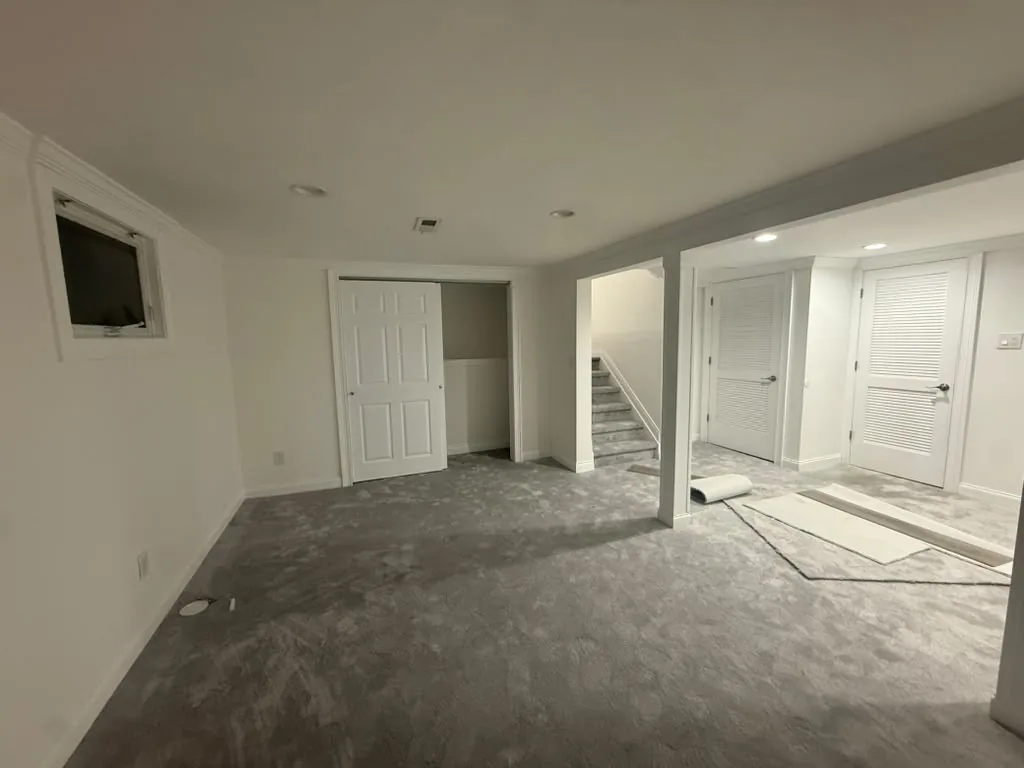 Finished basement with carpet and recessed lighting