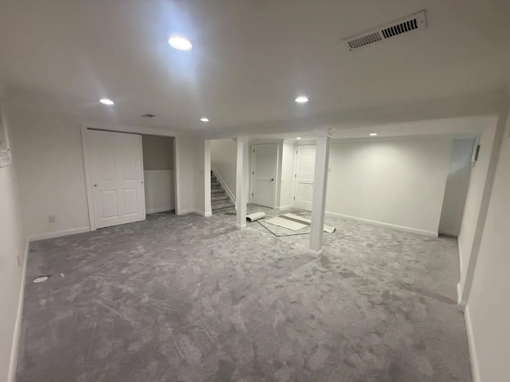 Finished basement with drywall, carpet and recessed lighting