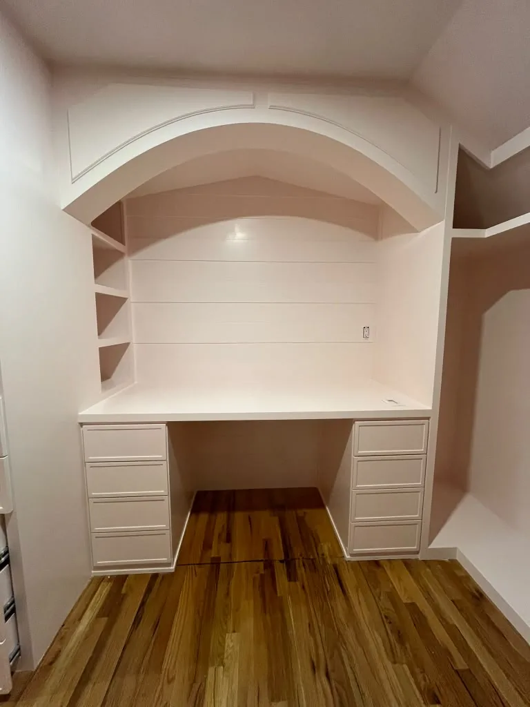 Arched built-in shelving over hardwood floors