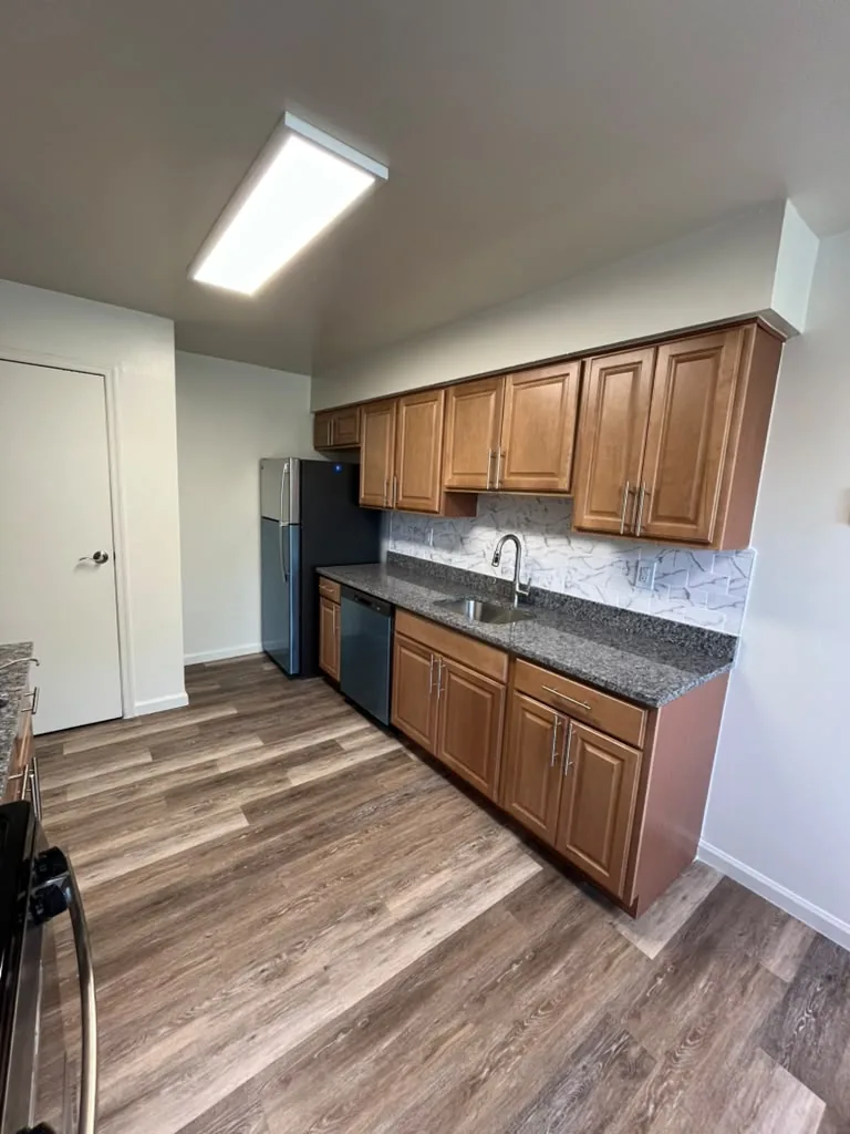 Kitchen with wood cabinets and dark countertops
