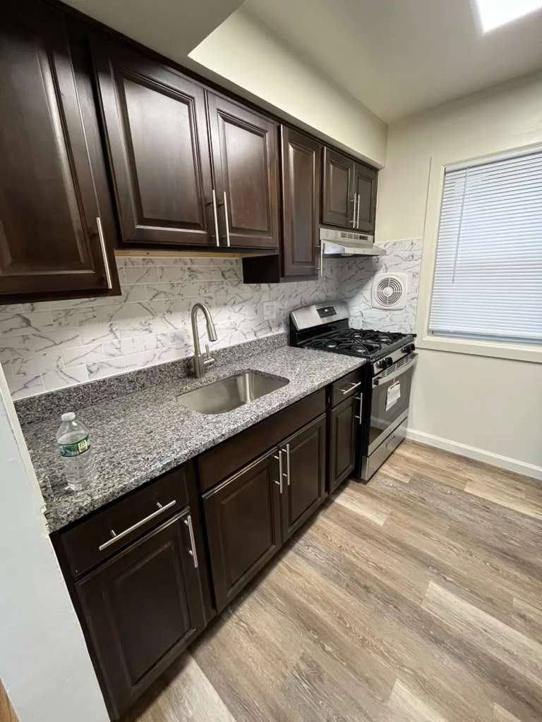 Renovated kitchen with espresso cabinets, granite counters and undermount sink