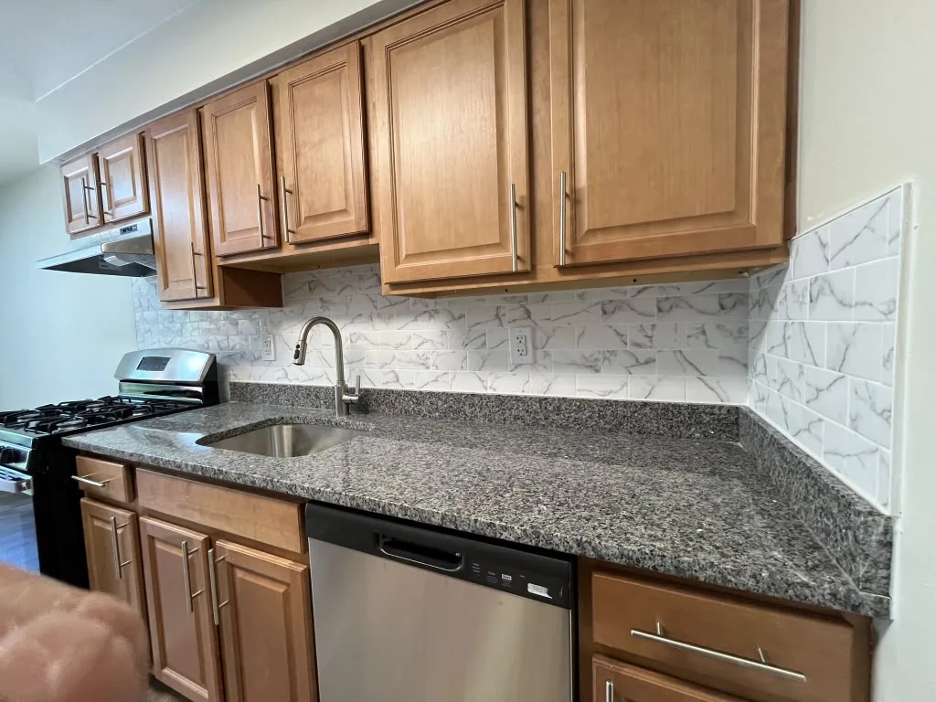 Kitchen run with granite counters, undermount sink and dishwasher