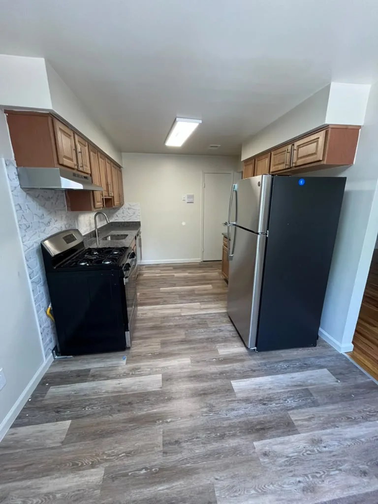 Kitchen with wood cabinets and stainless refrigerator
