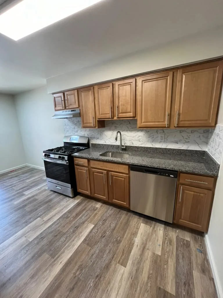 Kitchen with wood cabinets, granite counters and stainless appliances