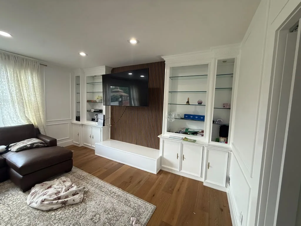 Living room finished and furnished with built-in cabinetry