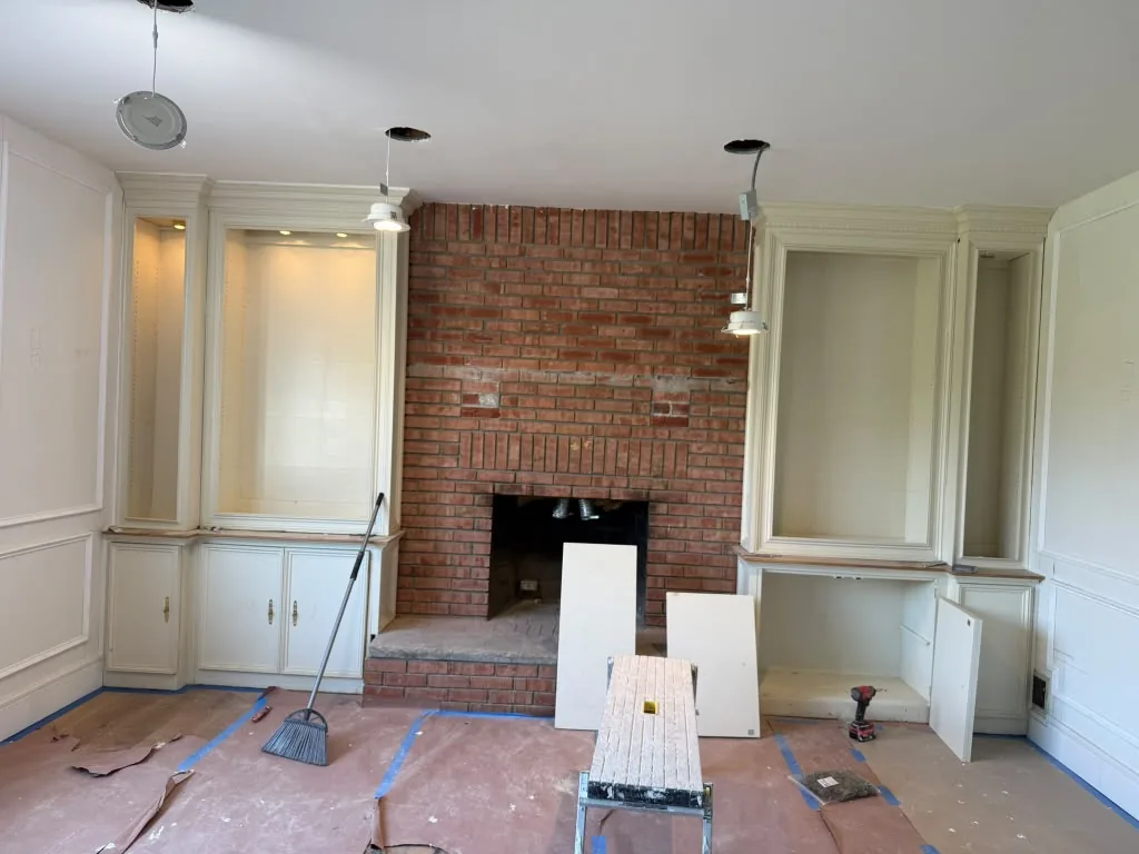 The same living room masked off and prepped for fine finish painting